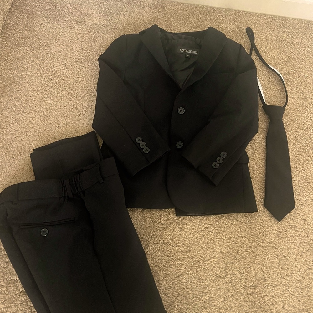 Boys Black tux. Includes Jacket, Vest, Tie, and dress pants. Size 6, 8, and 10.